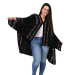 Load image into Gallery viewer, Woman wearing a black patterned shawl over a white top and blue jeans on a white background